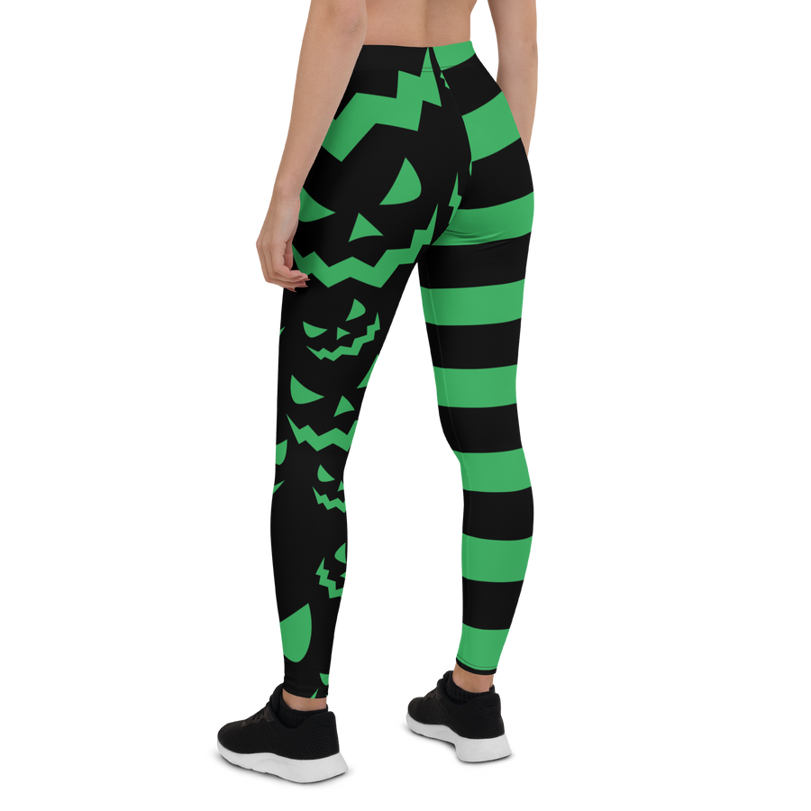 Green and black striped leggings with jack-o'-lantern face design – Halloween pumpkin leggings by Haunt Shirts