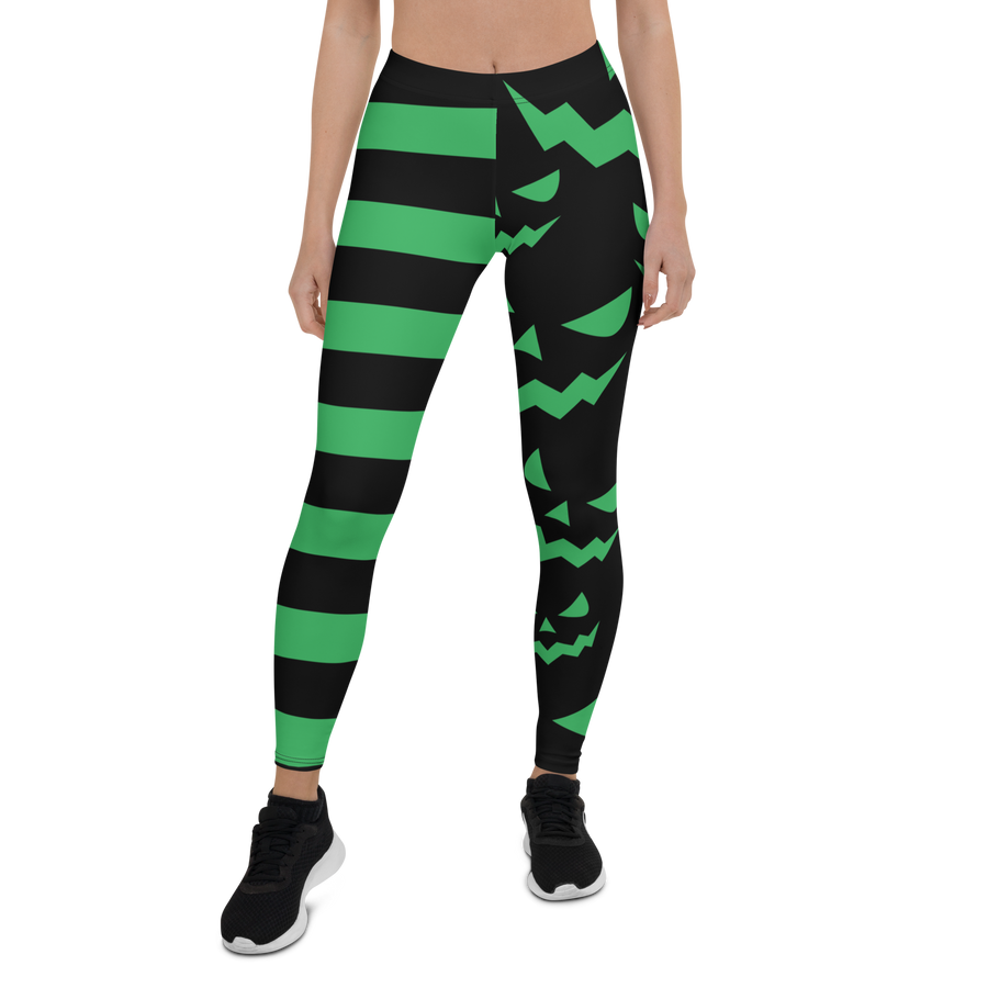Green and black striped leggings with jack-o'-lantern face design – Halloween pumpkin leggings by Haunt Shirts