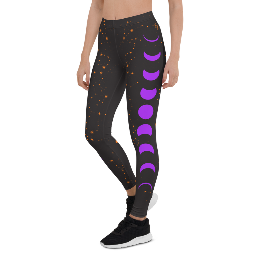 Ladies celestial leggings with orange stars and purple moon phases – cosmic design by Haunt Shirts